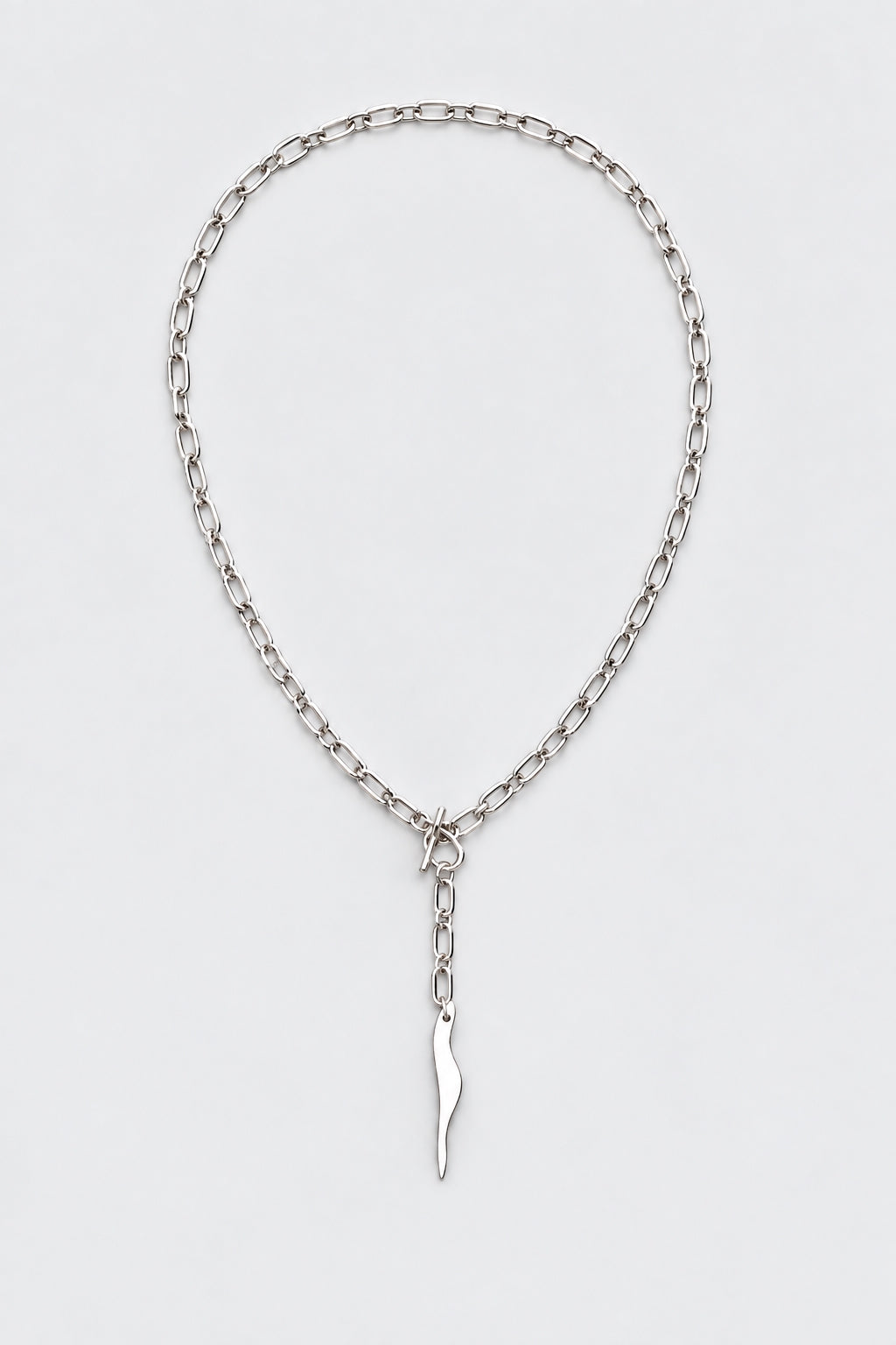 SARAH BOUNAB “Abyssal Flame” necklace in stainless steel with a polished aluminum flame pendant, handmade in Switzerland.