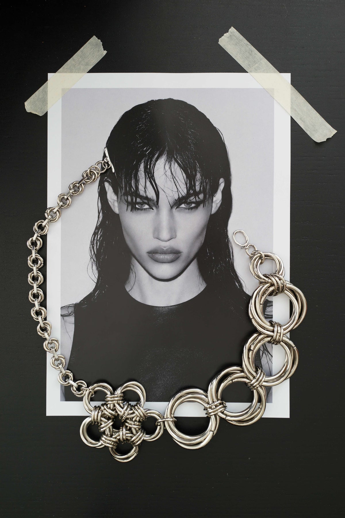 SARAH BOUNAB “Abyssal Thorn” necklace in stainless steel with metal knots and a polished aluminum petal pendant.