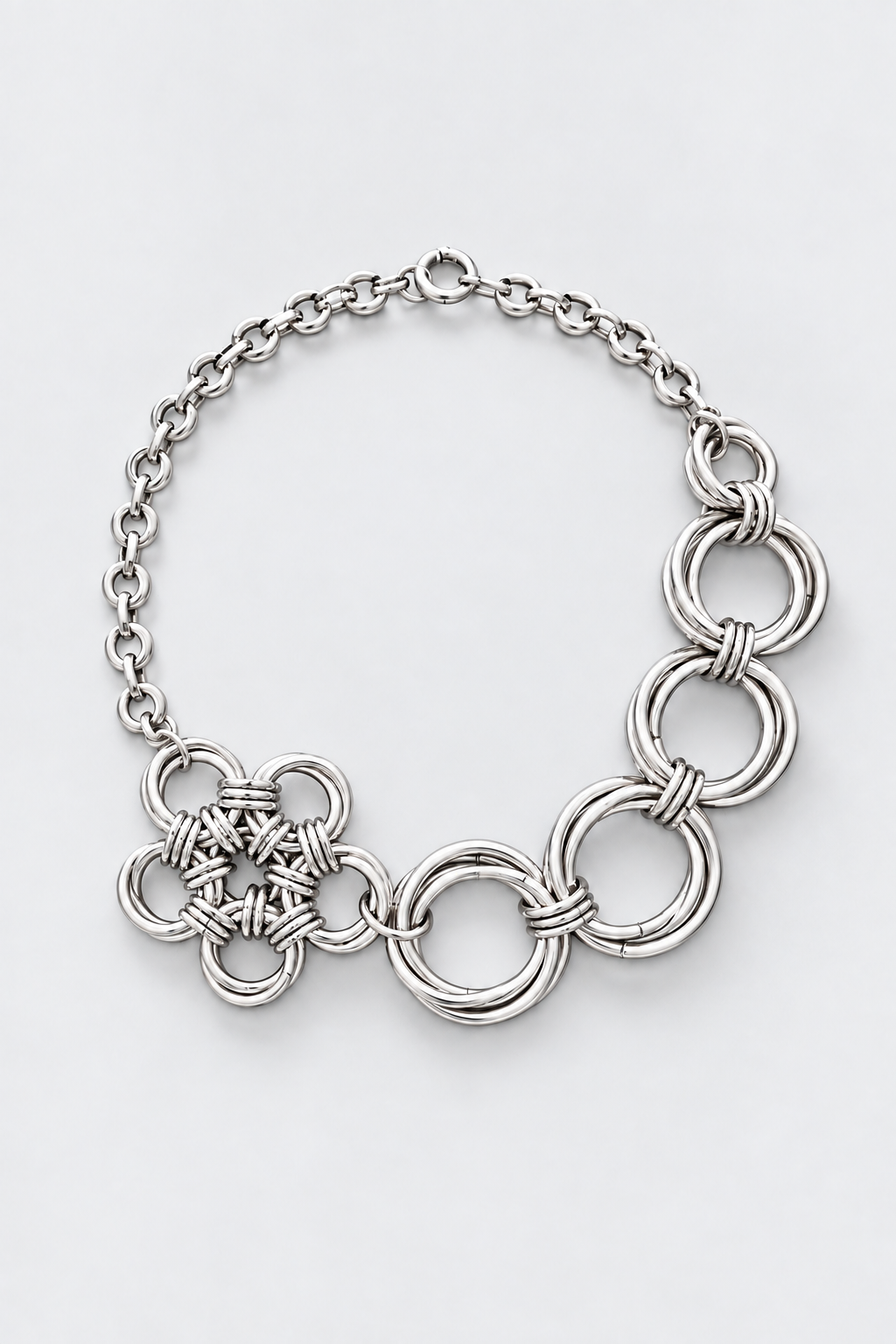 SARAH BOUNAB “Abyssal Thorn” necklace in stainless steel with metal knots and a polished aluminum petal pendant.