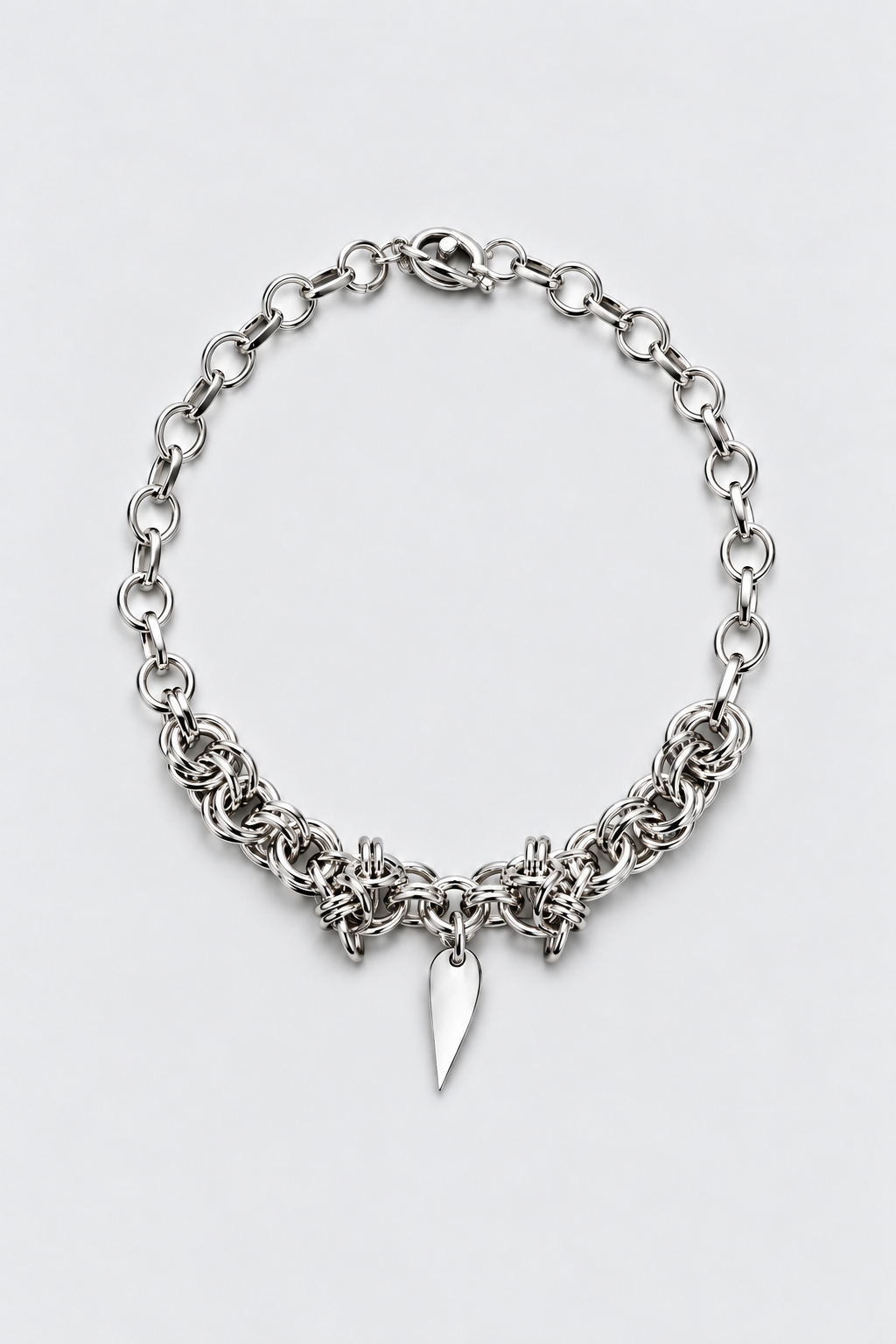 SARAH BOUNAB “Blade Heart” necklace in stainless steel with a mirror-polished aluminum tip pendant, handmade in Switzerland.