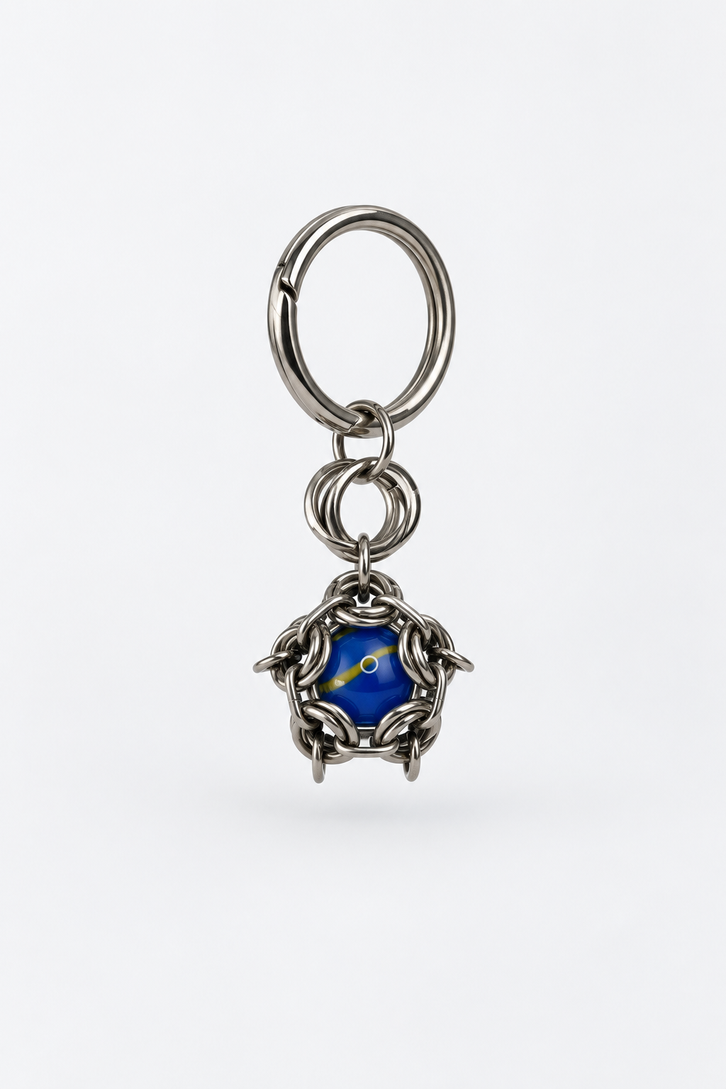 SARAH BOUNAB Cobalt Orbit keychain in stainless steel with a cobalt blue bead and yellow accent, handmade in Switzerland.
