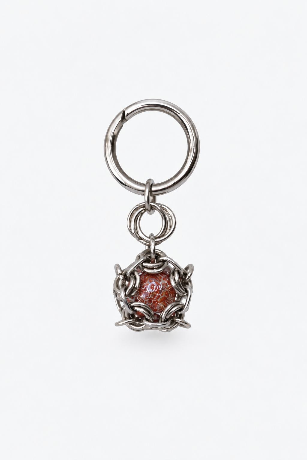 SARAH BOUNAB Ember Core keychain made of stainless steel with a marbled red-orange bead, handmade in Switzerland.