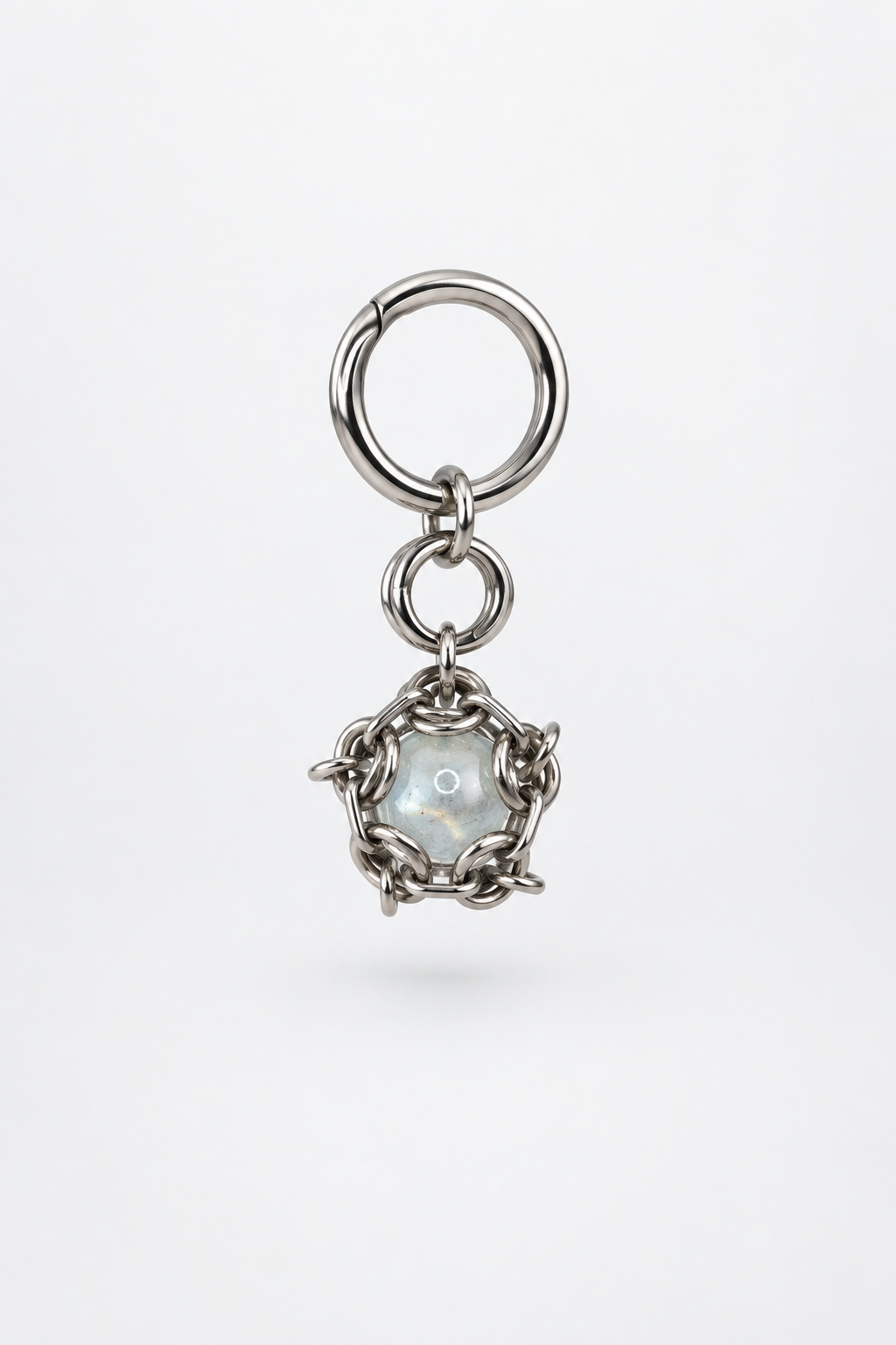 SARAH BOUNAB “Ice Core” stainless steel keychain with an ice-blue translucent bead, handmade in Switzerland.