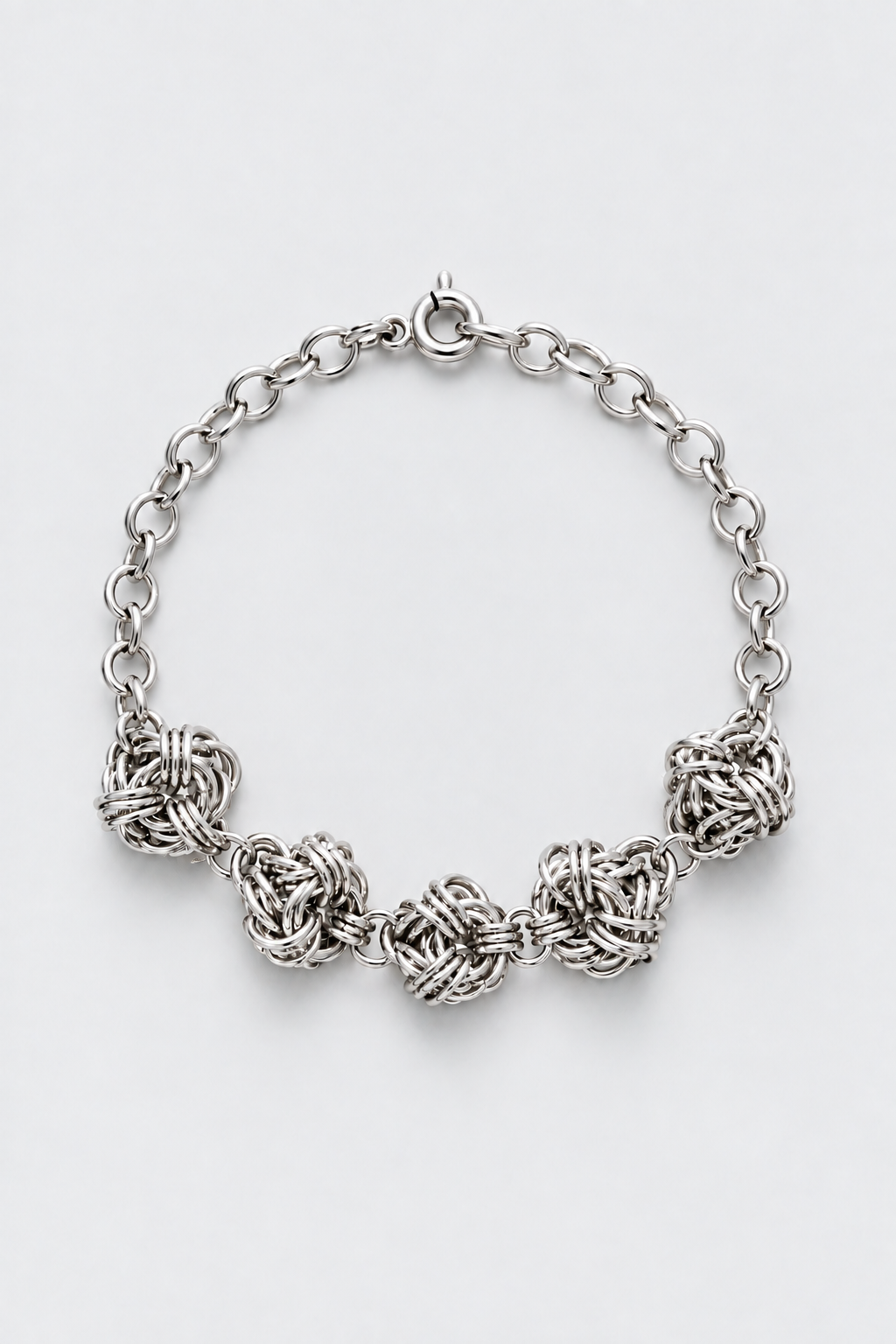 SARAH BOUNAB Orbital Knot Necklace, featuring five stainless steel ring knots, handcrafted in Switzerland.