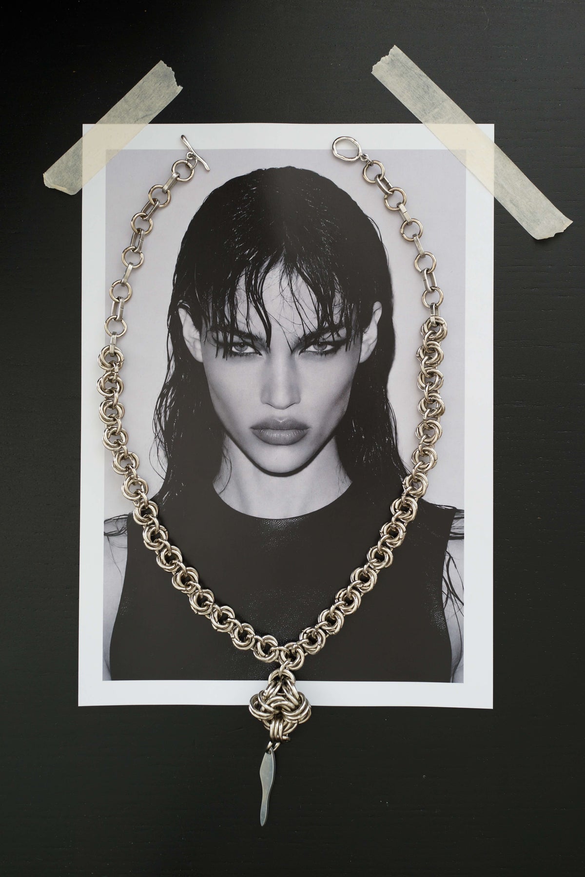 SARAH BOUNAB “Rift Talisman” necklace made of stainless steel mesh with a twisted pendant in mirror-polished aluminum.