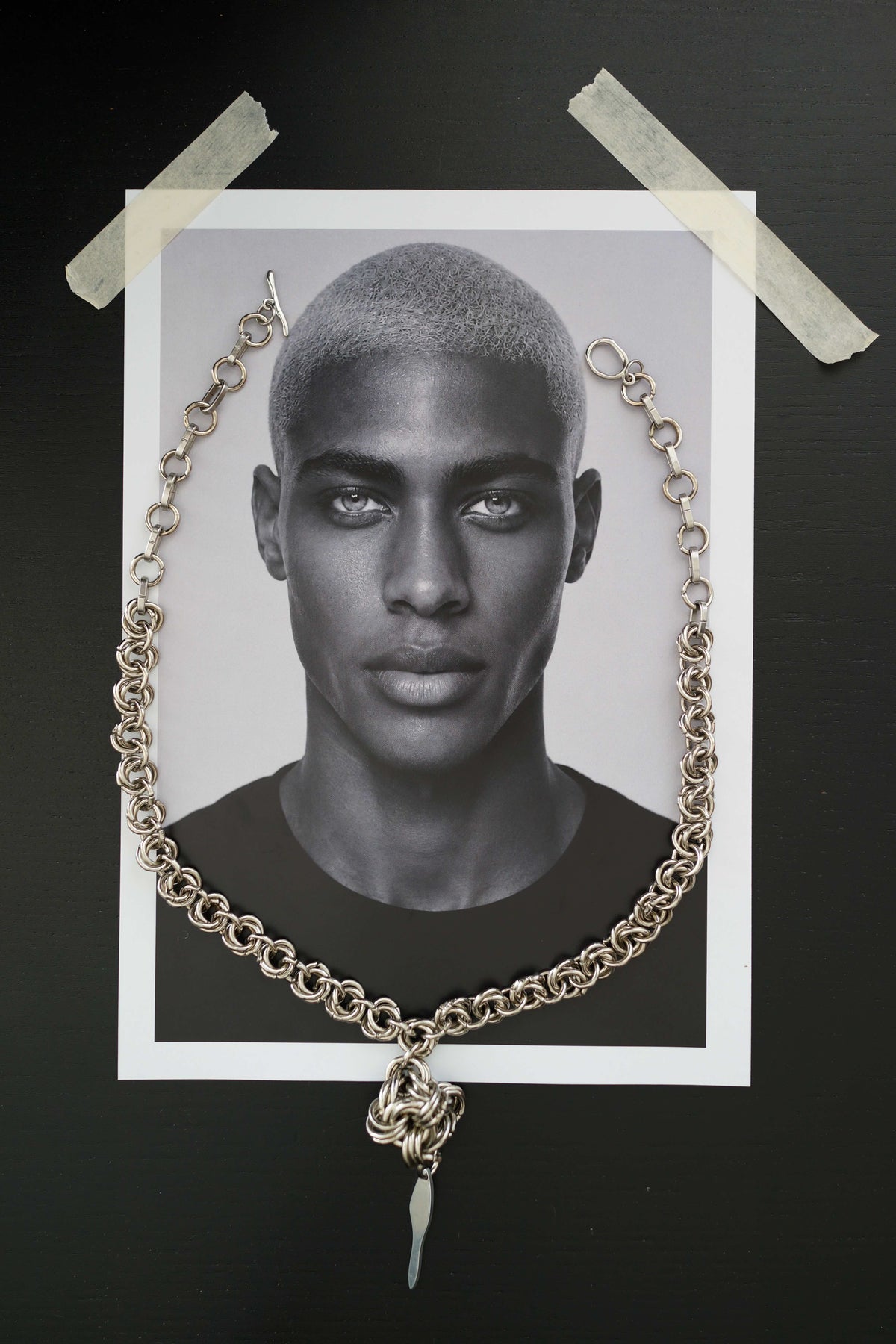 SARAH BOUNAB “Rift Talisman” necklace made of stainless steel mesh with a twisted pendant in mirror-polished aluminum.